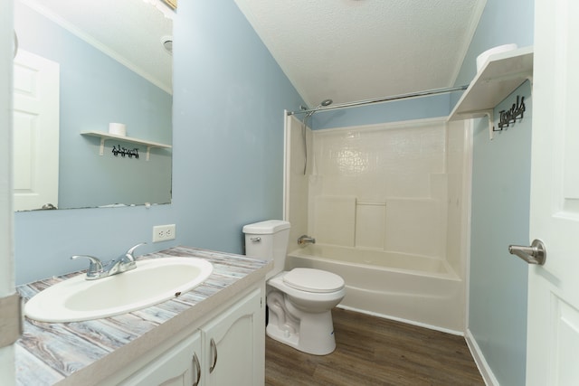 full bathroom featuring  shower combination, toilet, ornamental molding, a textured ceiling, and wood-type flooring