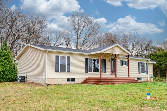 manufactured / mobile home featuring cooling unit and a front lawn