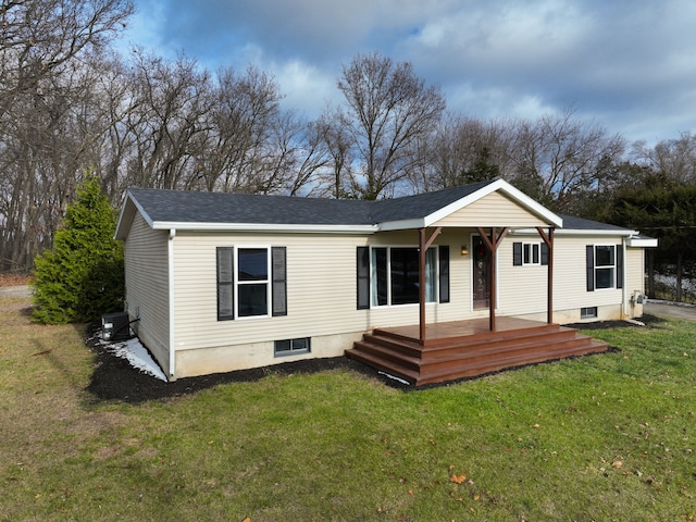 rear view of property with central AC unit, a porch, a yard, and a wooden deck