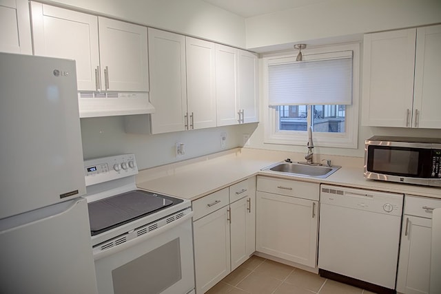 kitchen featuring sink, light tile patterned floors, white cabinets, and white appliances