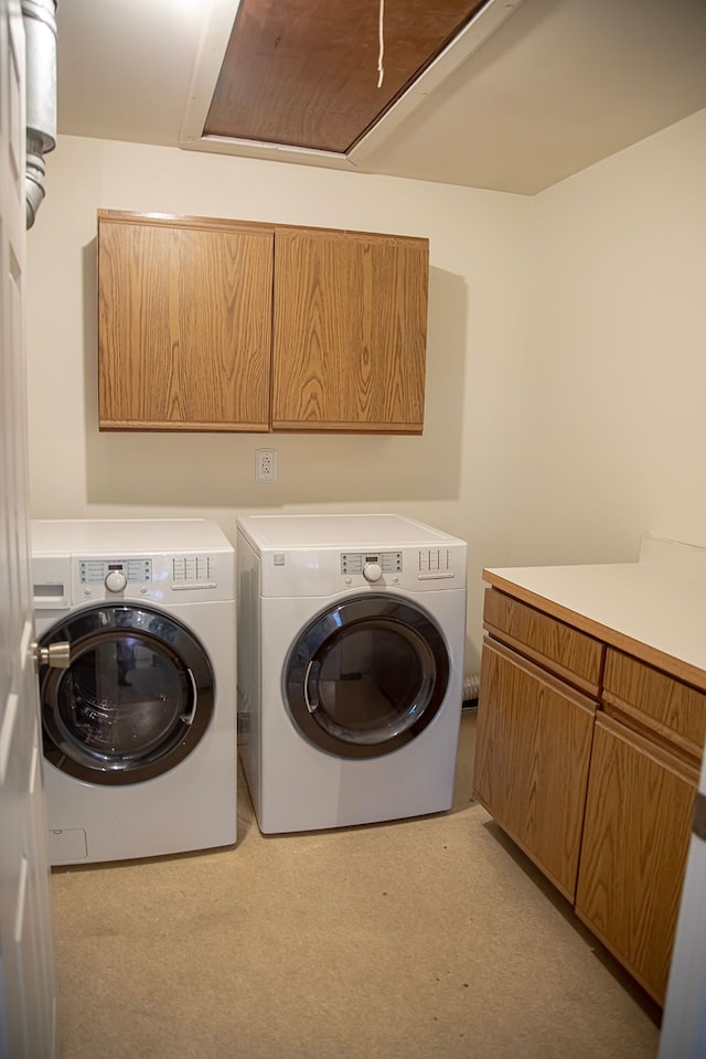 laundry area with cabinets and washing machine and dryer