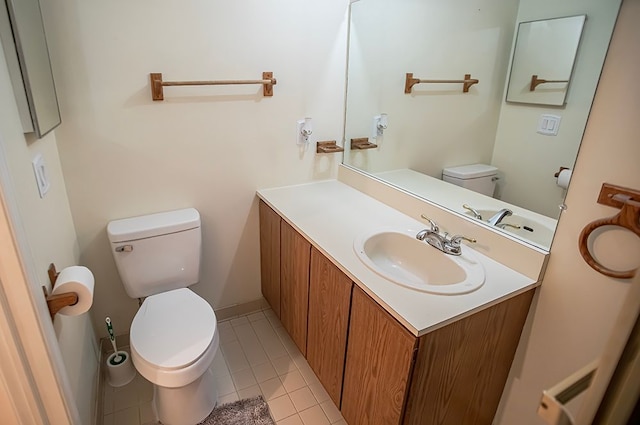 bathroom featuring vanity, tile patterned flooring, and toilet