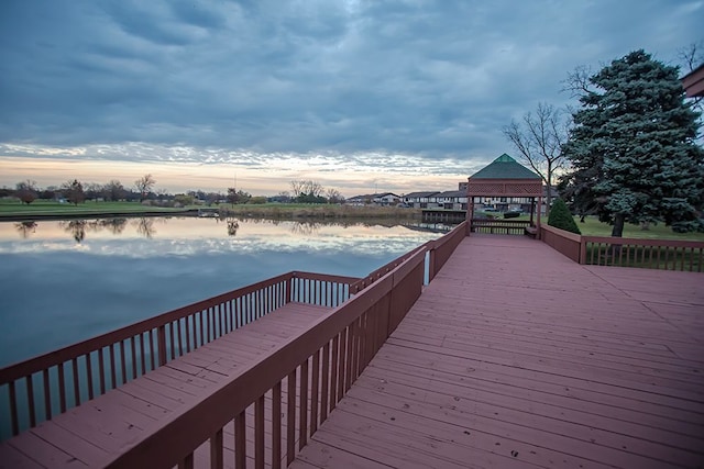 view of dock with a gazebo and a water view