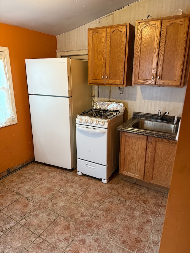 kitchen with white appliances and sink