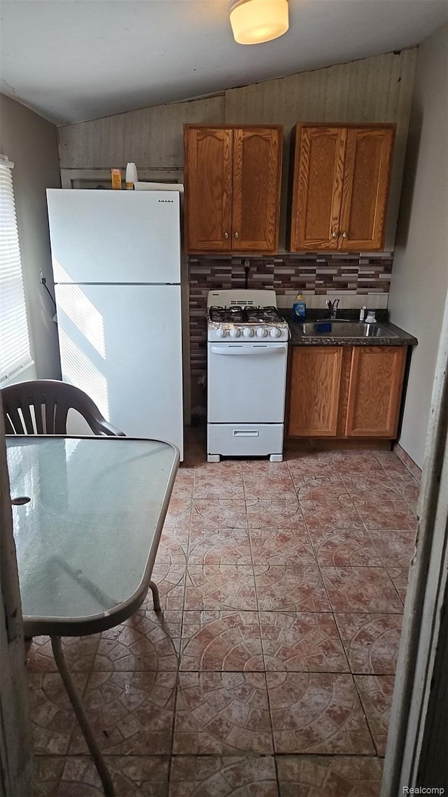 38 E Sheffield Ave, Pontiac, MI 48340 - kitchen with white appliances, brown cabinets, dark countertops, backsplash, and light tile patterned floors