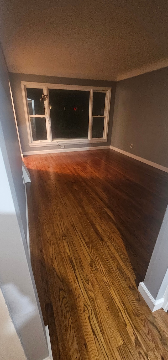 spare room with wood-type flooring and a textured ceiling