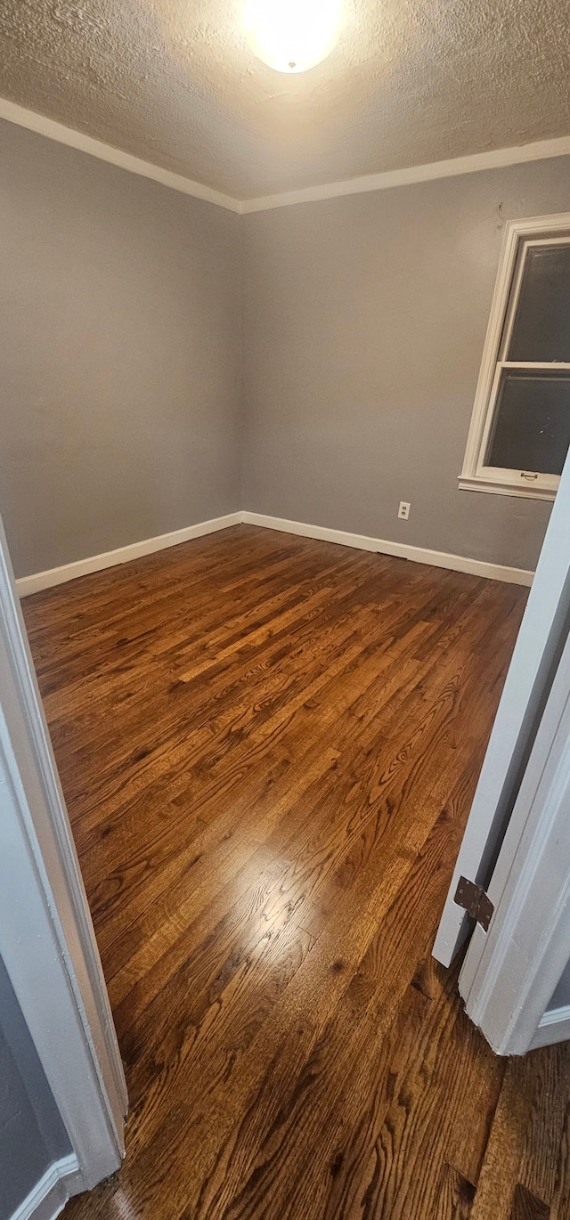 unfurnished room featuring a textured ceiling and dark hardwood / wood-style floors