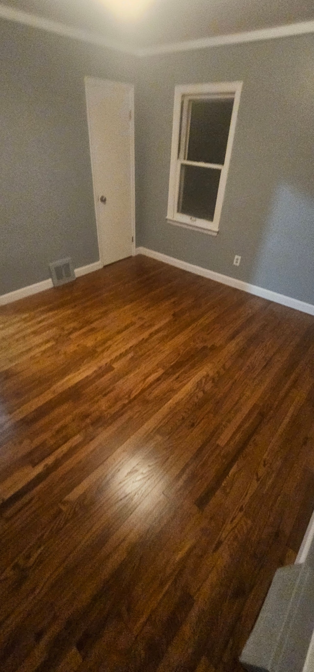 empty room featuring dark hardwood / wood-style flooring