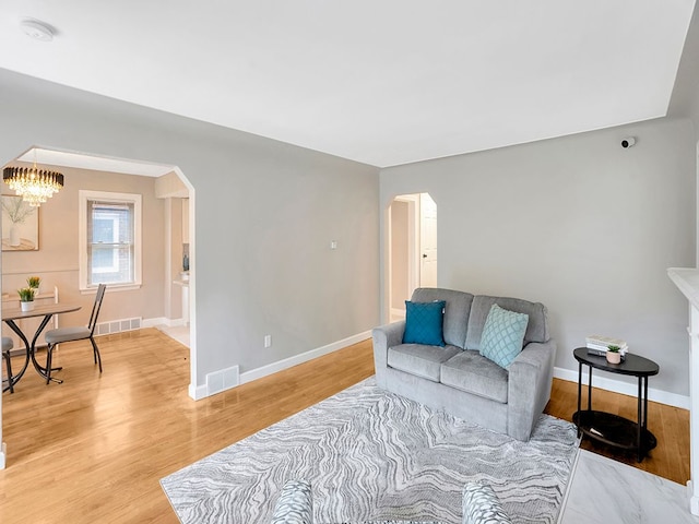 living room featuring a notable chandelier and hardwood / wood-style flooring