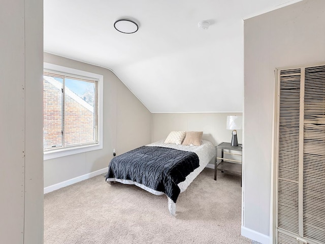 bedroom with light carpet and vaulted ceiling