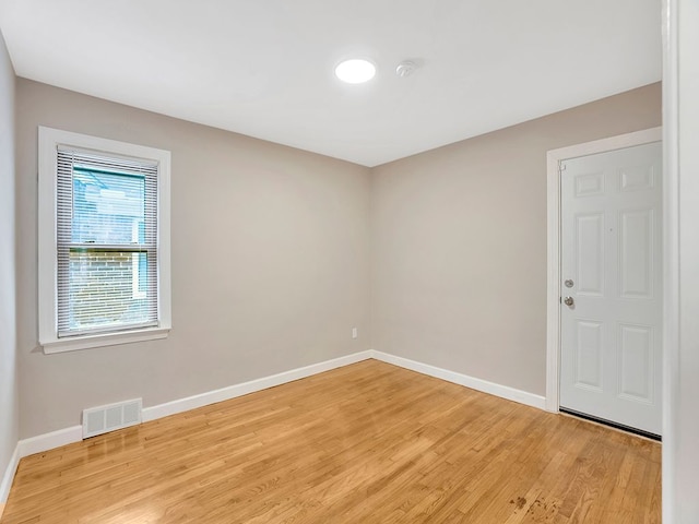 spare room featuring light hardwood / wood-style flooring