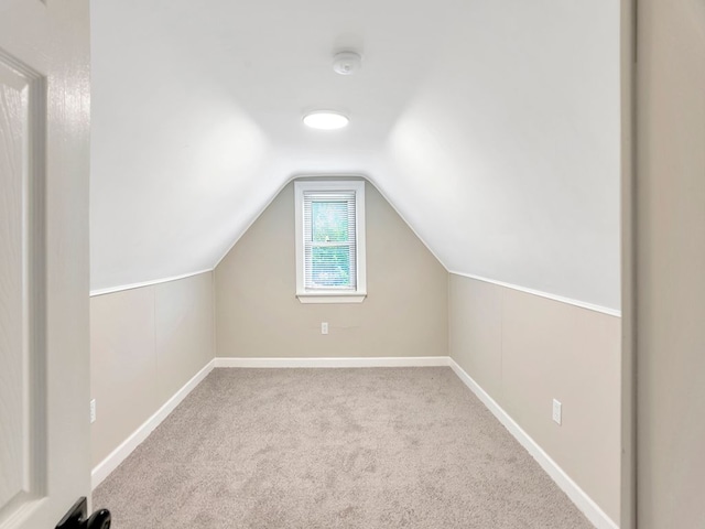 bonus room featuring light colored carpet and lofted ceiling