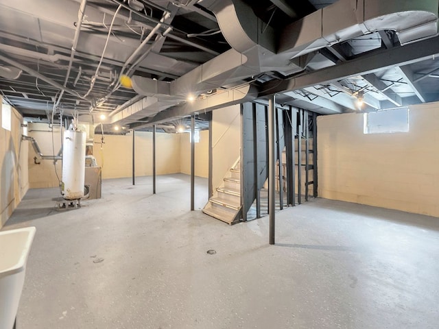 basement featuring gas water heater and sink