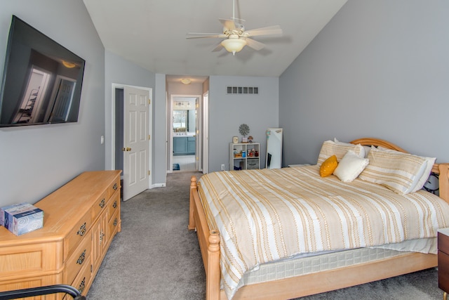 bedroom with carpet floors, ensuite bath, ceiling fan, and lofted ceiling