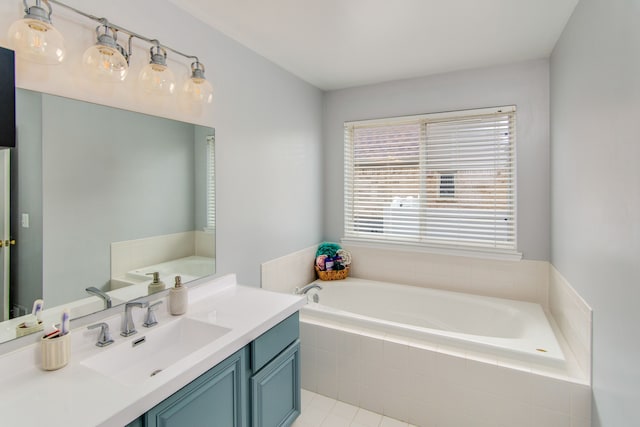 bathroom featuring tiled bath, tile patterned flooring, and vanity