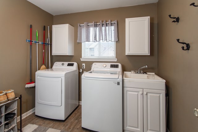 washroom featuring cabinets, dark hardwood / wood-style floors, separate washer and dryer, and sink