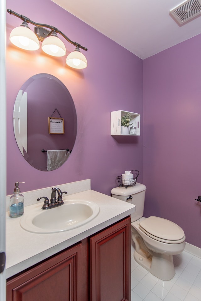 bathroom featuring tile patterned flooring, vanity, and toilet