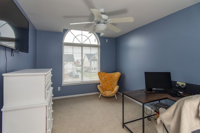 carpeted home office featuring ceiling fan