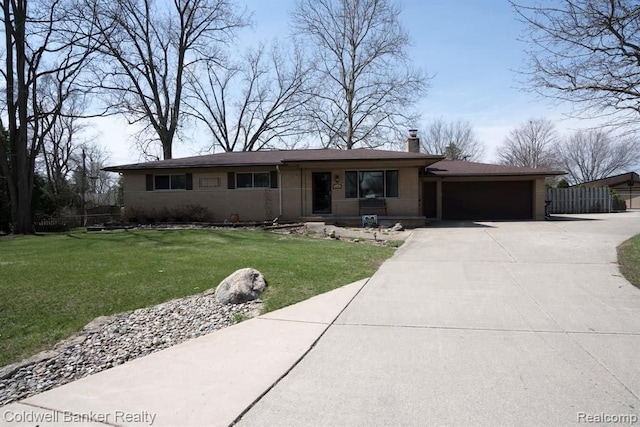 ranch-style house featuring a front yard and a garage