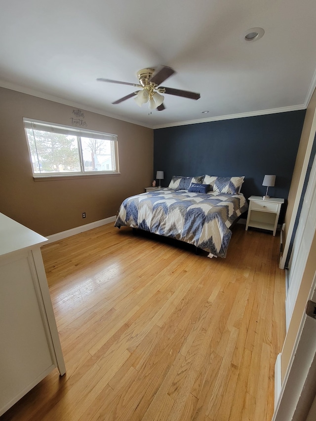 bedroom featuring ceiling fan, light hardwood / wood-style flooring, and crown molding