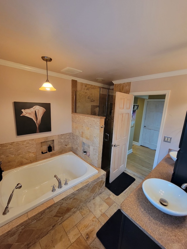 bathroom with vanity, ornamental molding, and shower with separate bathtub