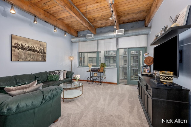 carpeted living room with beamed ceiling, wood ceiling, and rail lighting