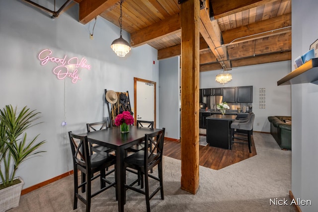 carpeted dining space featuring beam ceiling, wooden ceiling, and an inviting chandelier