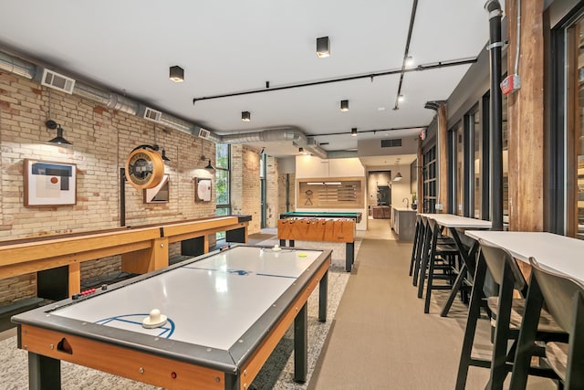 playroom with light colored carpet, billiards, and brick wall