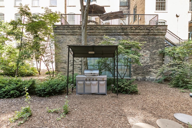 view of patio featuring a grill and a balcony