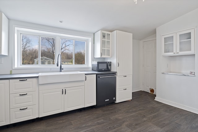 kitchen with dishwasher, white cabinetry, sink, and vaulted ceiling