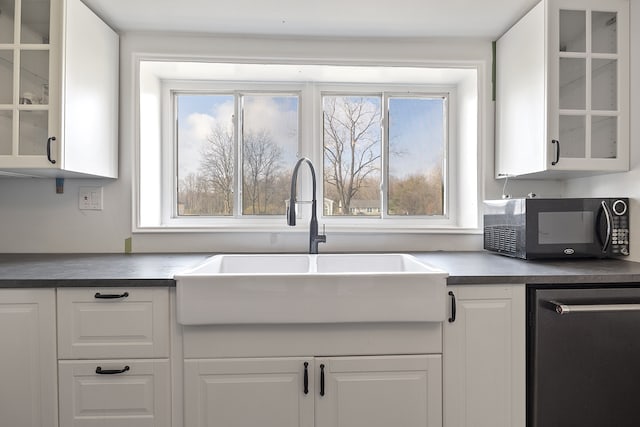 kitchen with white cabinetry, sink, and dishwasher