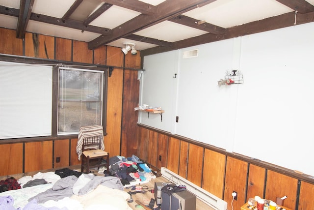 miscellaneous room with wooden walls and beamed ceiling