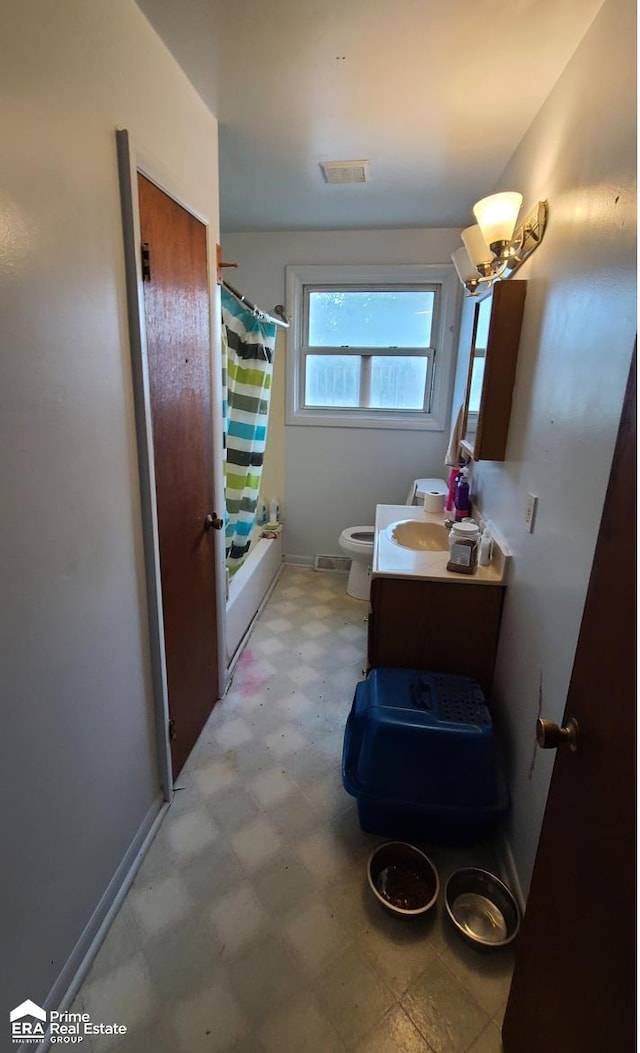 full bathroom with vanity, toilet, and shower / bath combo with shower curtain