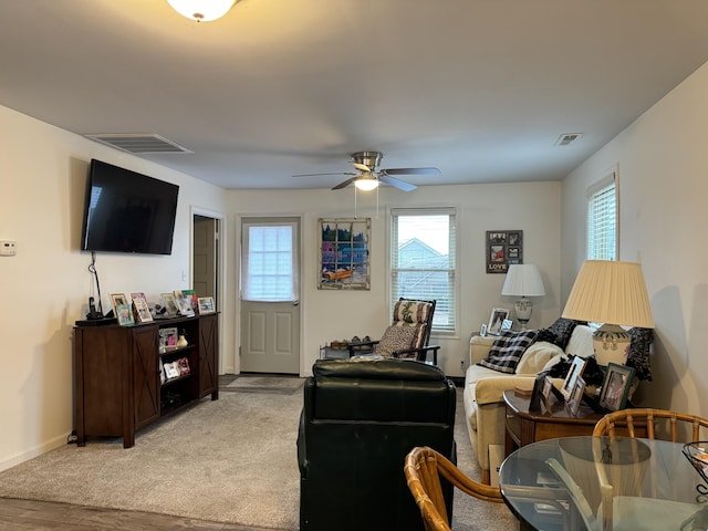 living room with ceiling fan, plenty of natural light, and light hardwood / wood-style flooring