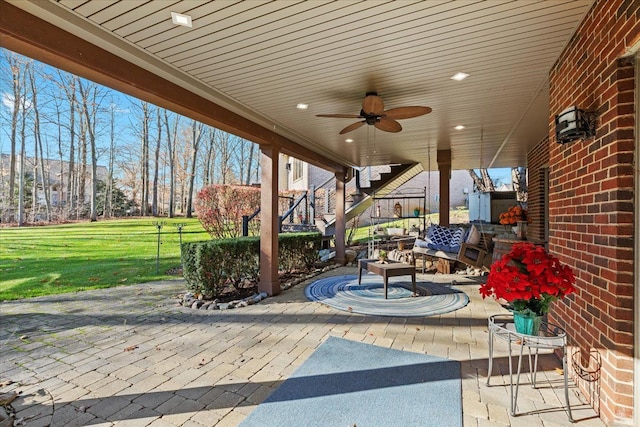 view of patio with outdoor lounge area and ceiling fan