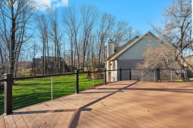 wooden terrace featuring a lawn