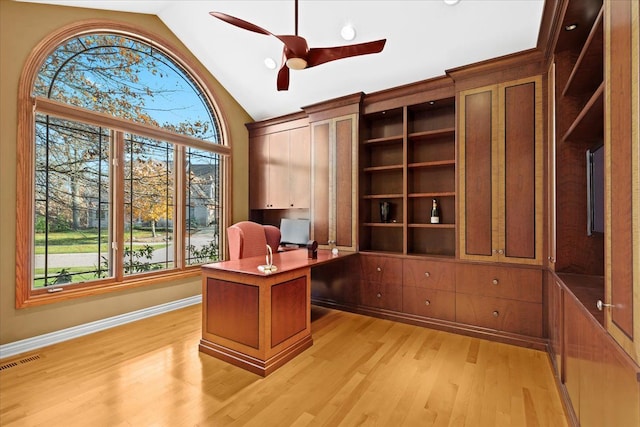 office space with ceiling fan, vaulted ceiling, and light wood-type flooring