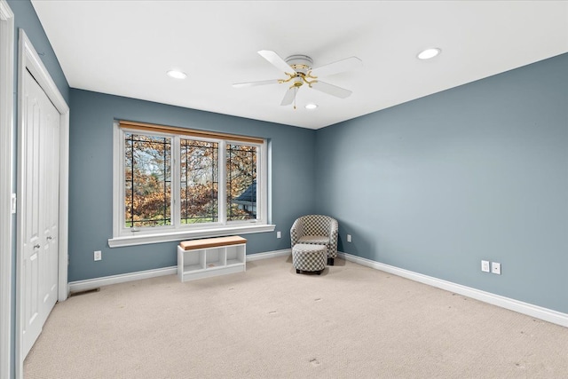 sitting room with light carpet and ceiling fan