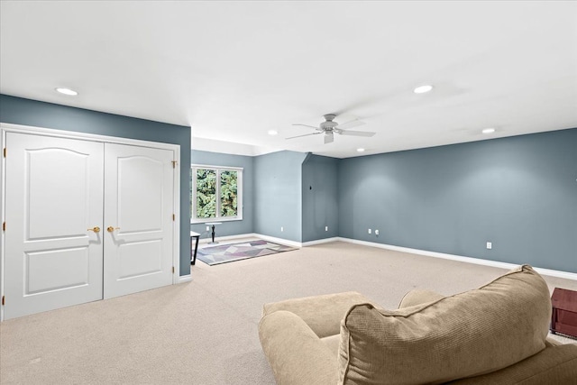 interior space featuring light carpet and ceiling fan