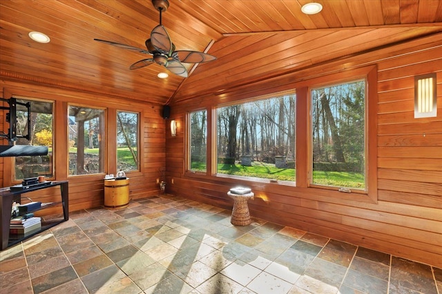 unfurnished sunroom with lofted ceiling, a healthy amount of sunlight, wooden ceiling, and ceiling fan