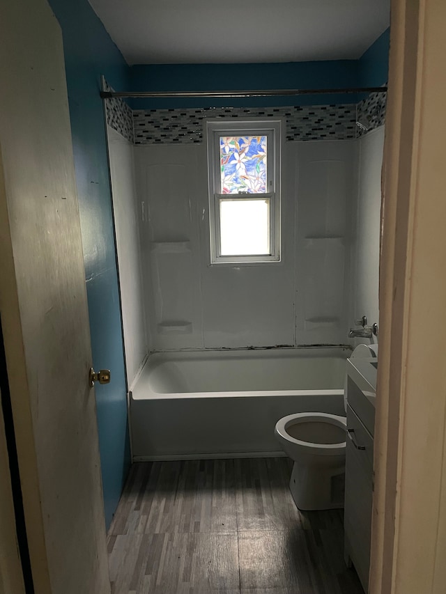 full bathroom featuring hardwood / wood-style floors, vanity, toilet, and shower / tub combination