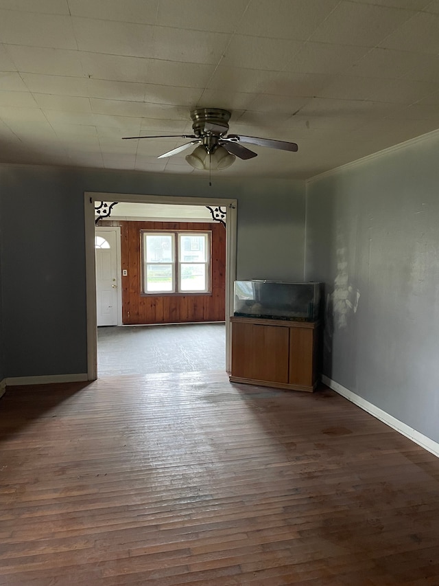 empty room featuring ceiling fan and dark wood-type flooring