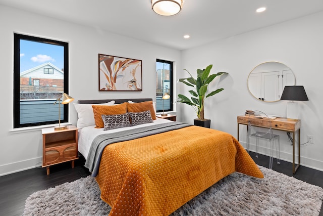 bedroom with dark hardwood / wood-style floors