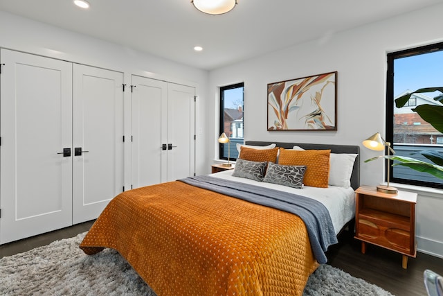 bedroom featuring multiple closets and dark hardwood / wood-style flooring