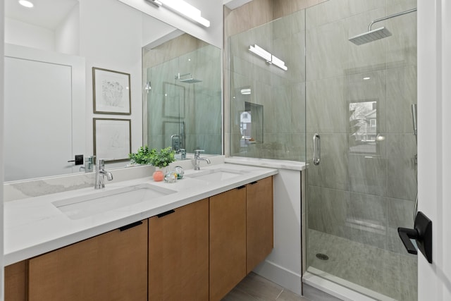 bathroom featuring a shower with shower door, vanity, and tile patterned flooring