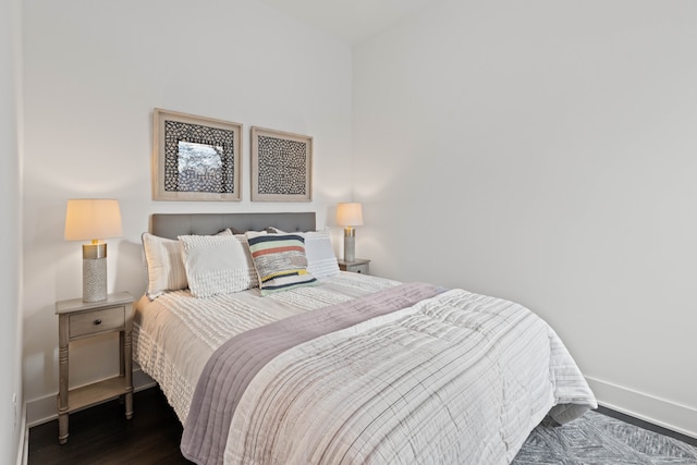 bedroom with dark hardwood / wood-style floors