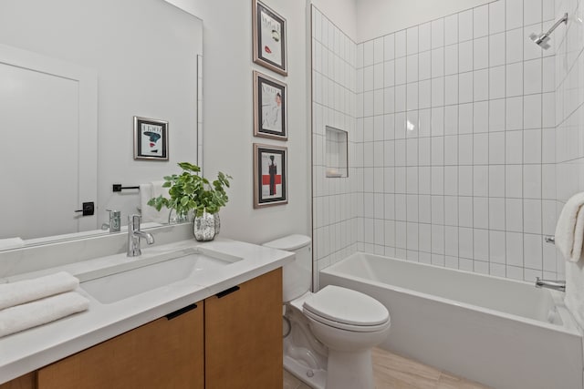 full bathroom featuring toilet, vanity, and tiled shower / bath combo