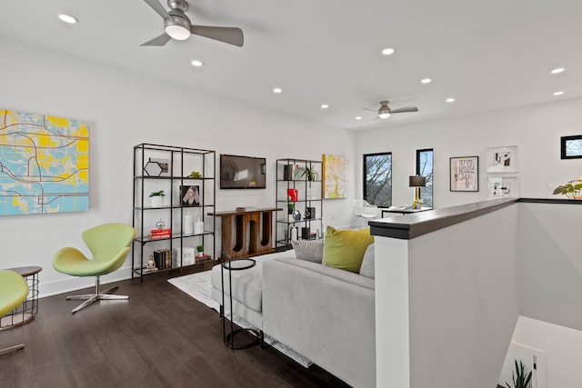 living room featuring ceiling fan and dark wood-type flooring