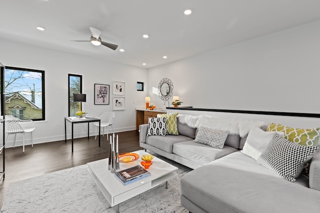 living room with ceiling fan and dark hardwood / wood-style flooring