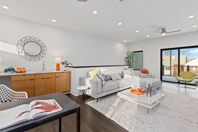 living room featuring ceiling fan, dark hardwood / wood-style floors, and sink